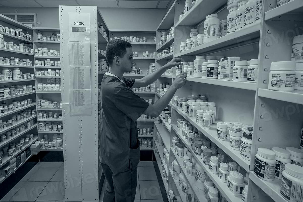 Shelves of packaged medicines in a modern pharmacy.