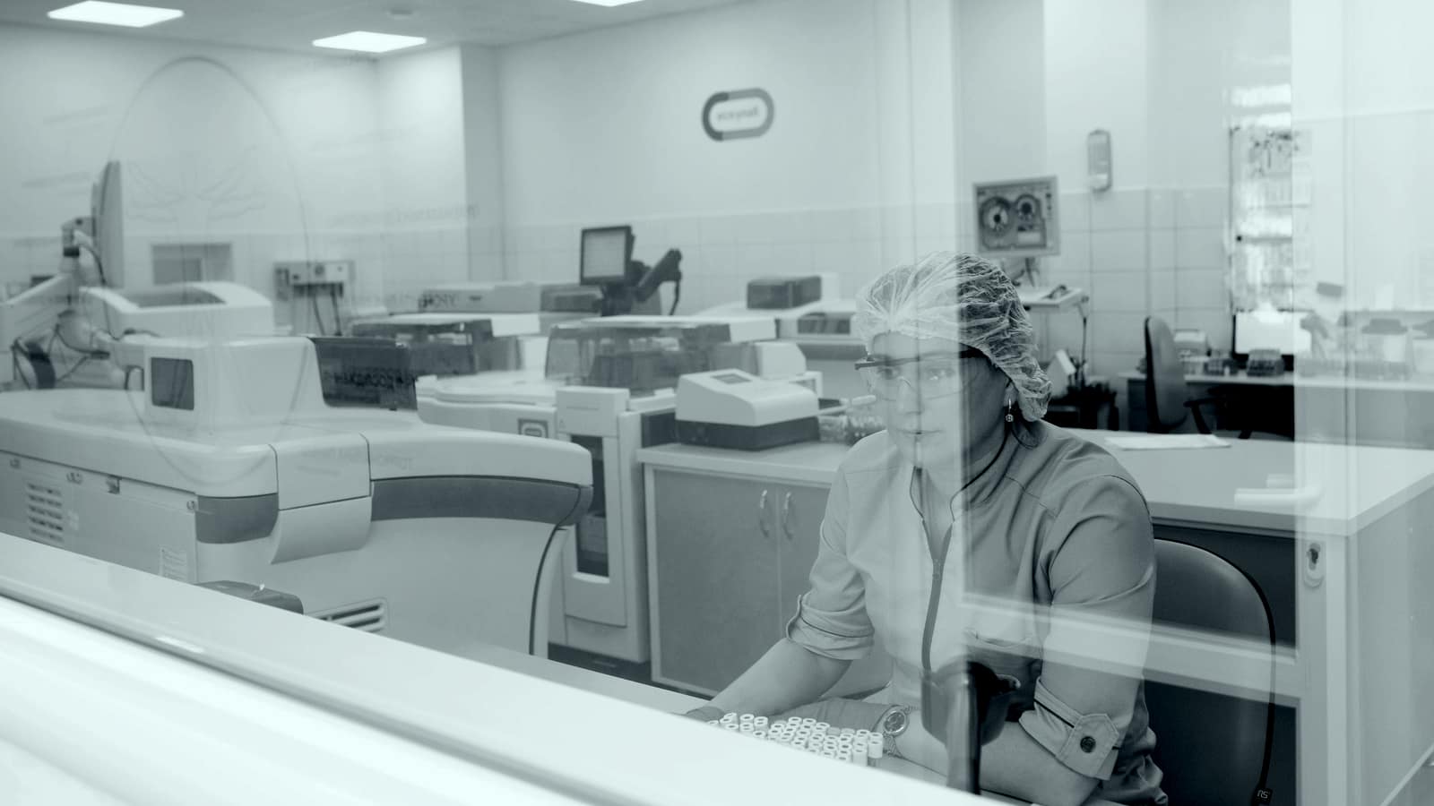 A technician working at a modern medical laboratory bench.